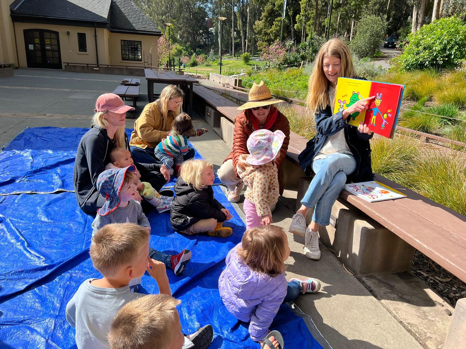 Families gathered outdoors for storytime